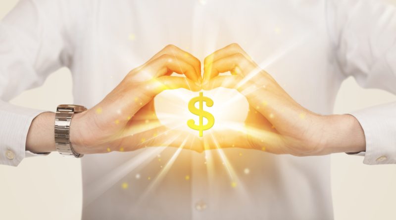 hands creating a heart shape with a dollar sign in the center