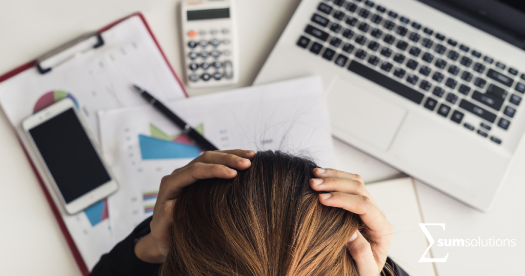 Frustrated woman at desk with financial documents