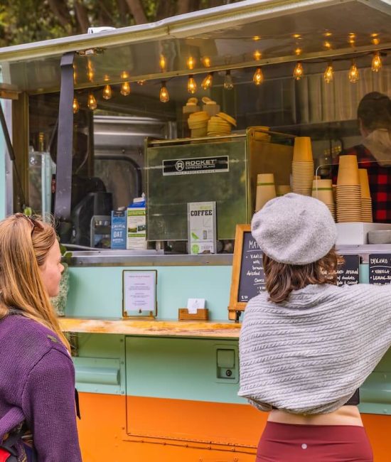 People buying coffee from a coffee truck.